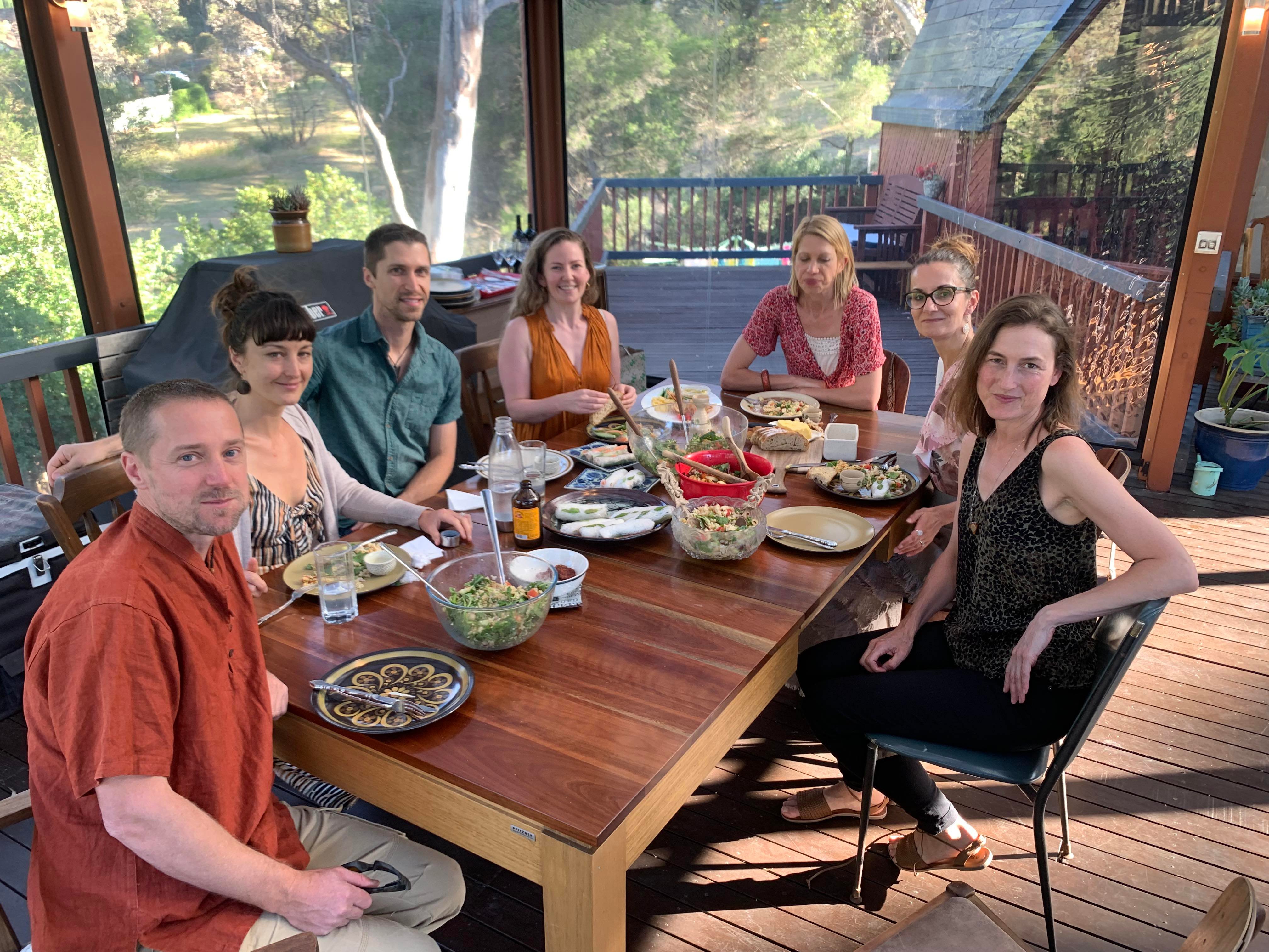 seven people eating together on a patio